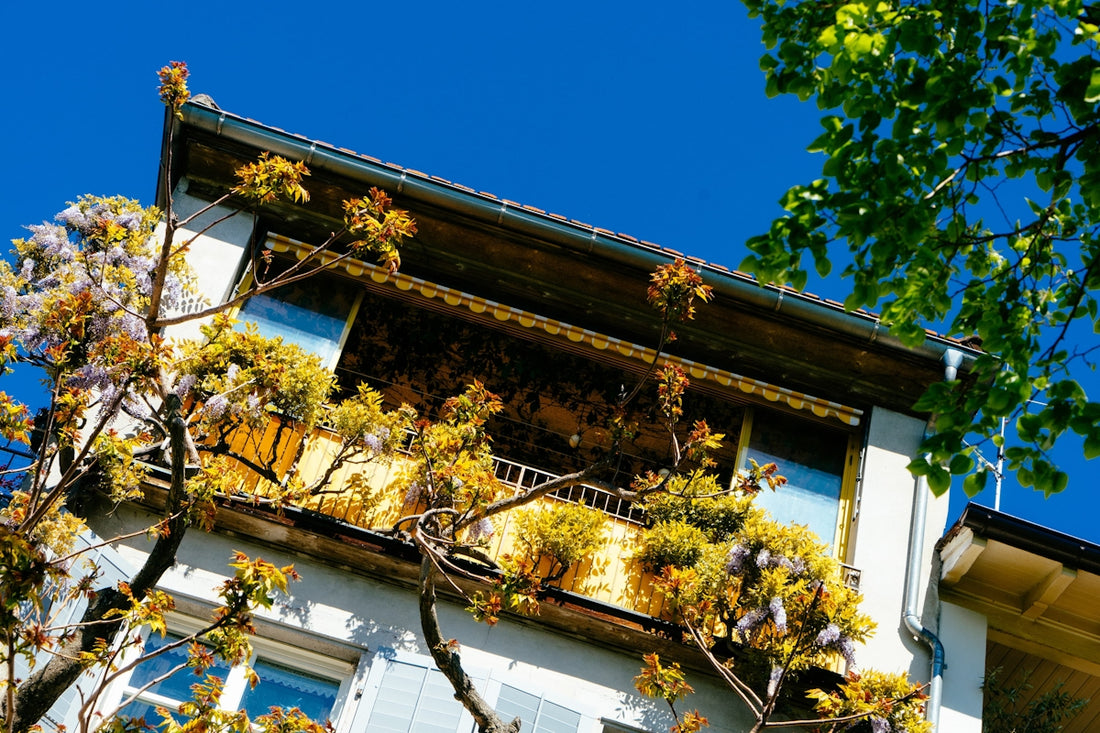 a tall building with lots of plants growing on it