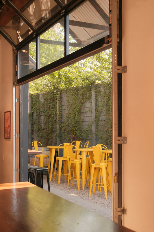 Open door reveals a sunny outdoor patio.