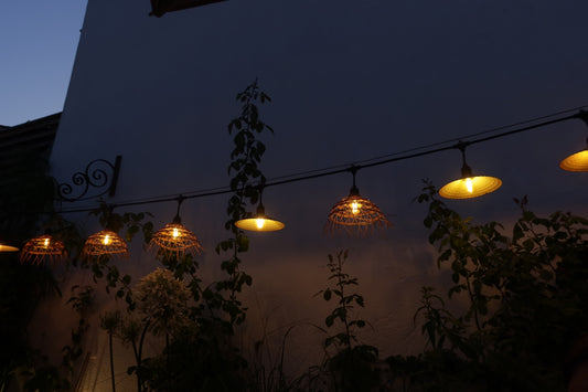 Outdoor string lights illuminate the night sky.