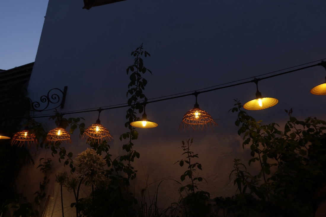 Outdoor string lights illuminate the night sky.
